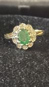 9ct Gold ring set with central emerald surrounded