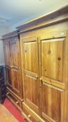 Pair of pine wardrobes with base drawers