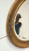 Gilt oval wall mirror