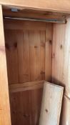 Solid pine two-door wardrobe, moulded cornice above panelled doors, fitted interior hanging rail,