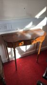 Mahogany serpentine-front hall table with twin drawers, brass knob pulls, fluted frieze detailing