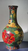 Cloisonné surround around ceramic vase