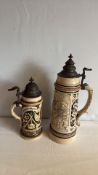Pair of German stoneware beer steins with pewter lids