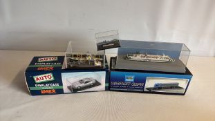 Group of three miniature ship models in display cases