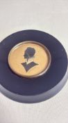 Round framed signed silhouette
