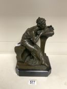 A BRONZE SCULPTURE OF A SEATED NEOCLASSICAL LADY RESTING HER HEAD ON A CUSHIONED PLINTH, BASE