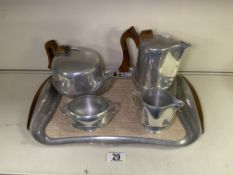 AN ART DECO PICQUOT WARE FOUR-PIECE TEA SERVICE AND WALNUT HANDLED RECTANGULAR TRAY
