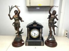 AN ANTIQUE BLACK MANTEL CLOCK, ROMAN NUMERALS AND A PAIR OF SCULPTURES, IMPRESSED 'KOSSOWSKI', ONE