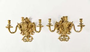 A pair of three light wall sconces