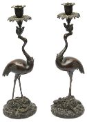 A pair of William IV patinated bronze candlesticks in the manner of Abbot & Co