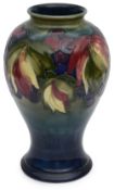 William Moorcroft (1872-1945): A leaf and berry pattern baluster vase