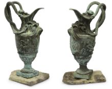 A pair of ornamental verdigris bronze ewers after the antique