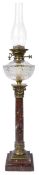 A late 19th century ormolu and red marble Corinthian column oil lamp