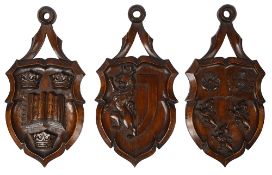 A set of three carved wood wall hanging armorial shields