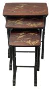 A Japanese black and red lacquer nest of three occasional tables