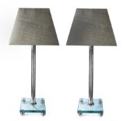 A pair of contemporary chrome and glass column table lamps