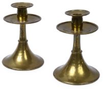 Omar Ramsden. A pair of Arts and Crafts planished brass candlesticks