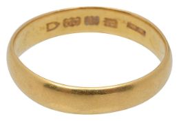 A 22ct band ring dated 1910-1911