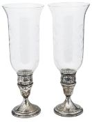 A pair of American silver candle holders with glass hurricane shades