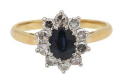An 18ct diamond and sapphire cluster ring
