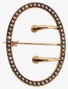 An Edwardian half pearl brooch in the form of a buckle