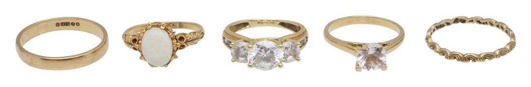 A 9ct opal ring, a three stone ring, two bands and one more