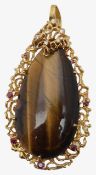 A large 18ct gold diamond and ruby 70s tigers eye pendant