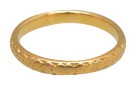 A 22ct wedding band dated 1933-34