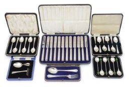 A collection of cased silver coffee spoons and other cased sets