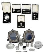 A collection of silver to include cased sets and a pair of photograph frames