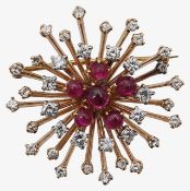 An elegant ruby and diamond floral brooch