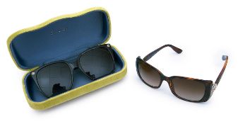 A pair of Gucci black sunglasses together with a pair of Bulgari sunglasses