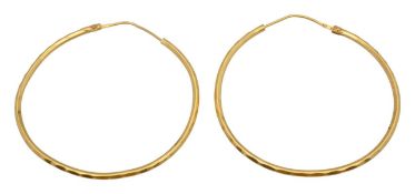 A pair of yellow gold hoop earrings