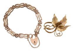 A 9ct gold stylish 70's leaf brooch with a heart lock gate bracelet
