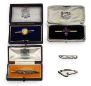 A 9ct Victorian garnet pin, art nouveau medal pin and three more