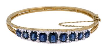 A Victorian style 9ct gold sapphire and diamond stiff bangle