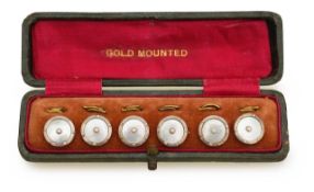 A complete set of gold mounted dress studs