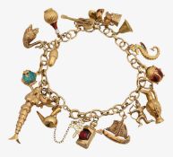 A 9ct charm bracelet with five 18ct charms and others