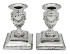 A pair of Victorian silver Adam style dwarf candlesticks (2)