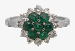 An emerald and diamond cluster ring
