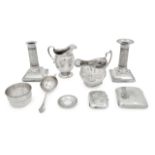 A pair of Edwardian dwarf silver column candlesticks, cream jugs etc., (7)