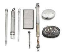 A collection of silver vertu to include pencils, pill boxes and a pocket lighter