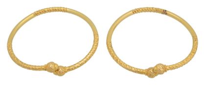 A pair of torque bangles