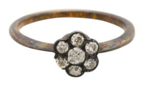 A diamond daisy cluster ring