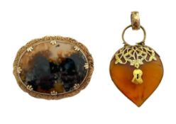 An amber and gold locket charm and agate brooch,