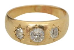 A diamond three stone gypsy set ring