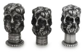 A late Victorian novelty cast silver cane top and two others