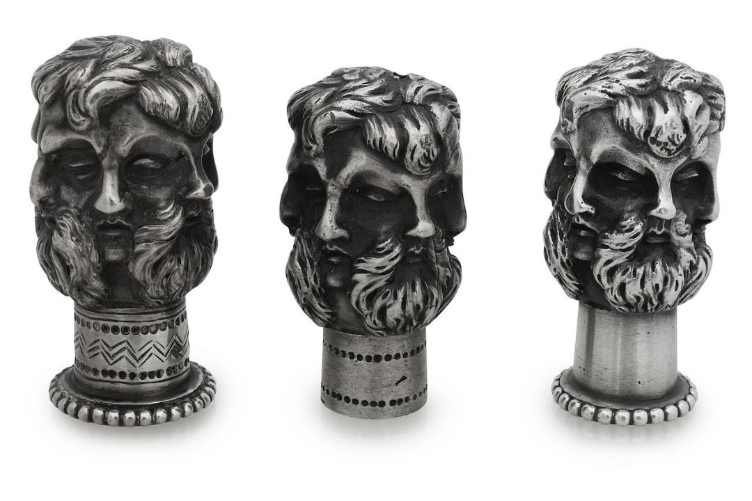 A late Victorian novelty cast silver cane top and two others