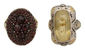 A garnet ring and a citrine and diamond set ring