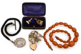 An Edward VII and Alexandra coin, amber beads and three other